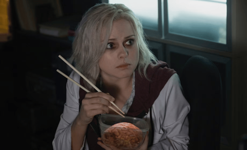 woman holding a brain in a bowl and chopsticks